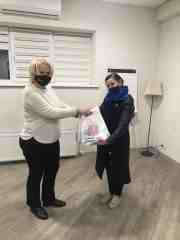 Elena giving bags to teacher